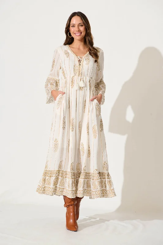 Sheer maxi dresses with lace overlays for a romantic touchEllie Maxi Dress In White With Gold Print Sheer maxi dresses with lace overlays for a romantic touchEllie Maxi Dress In White With Gold Print