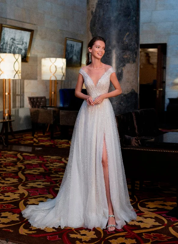 Wedding guest dresses with keyhole backs and flowing fabricsGlitter Wedding Gown with Cape Sleeves Wedding guest dresses with keyhole backs and flowing fabricsGlitter Wedding Gown with Cape Sleeves